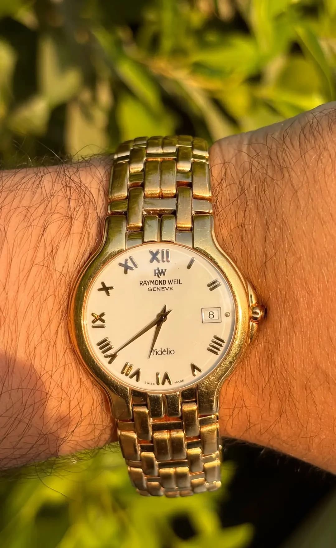 Raymond Weil Fidélio with a cream dial and gold-tone bracelet, worn on the wrist